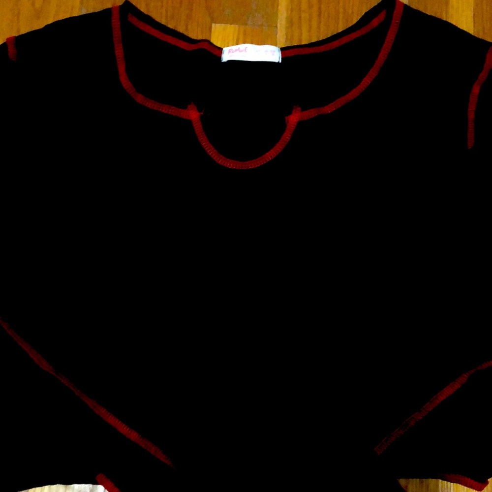 Black long sleeve with red contrast stitching.